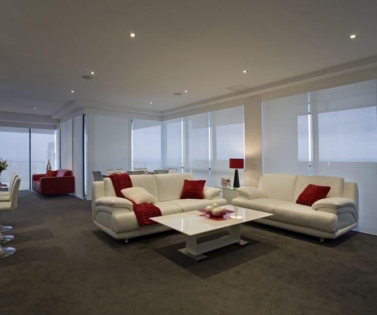 Office with red and white design, with windows covered with sheer white Roller/Holland Blinds.