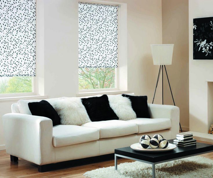 Elegant white and black living room featuring sheer Roller/Holland Blinds filtering sunlight into the room.