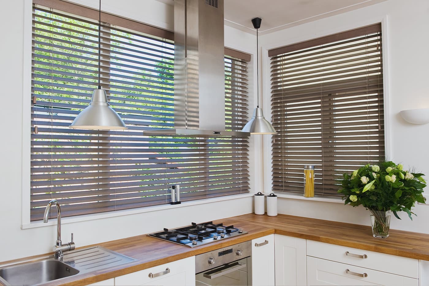 Timber Venetian Blinds installed in a modern kitchen with wooden furnishings.