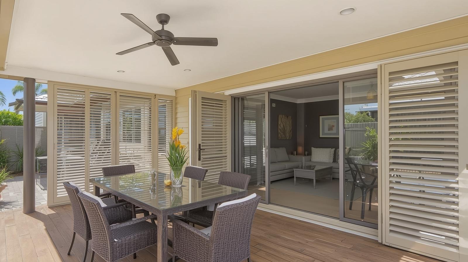 External aluminium plantation shutters on Brisbane patio providing shade and privacy for outdoor living