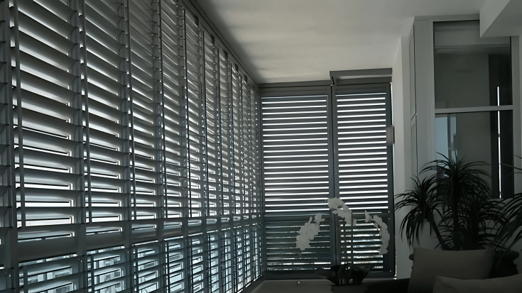External aluminium shutters on a Brisbane patio providing shade and privacy