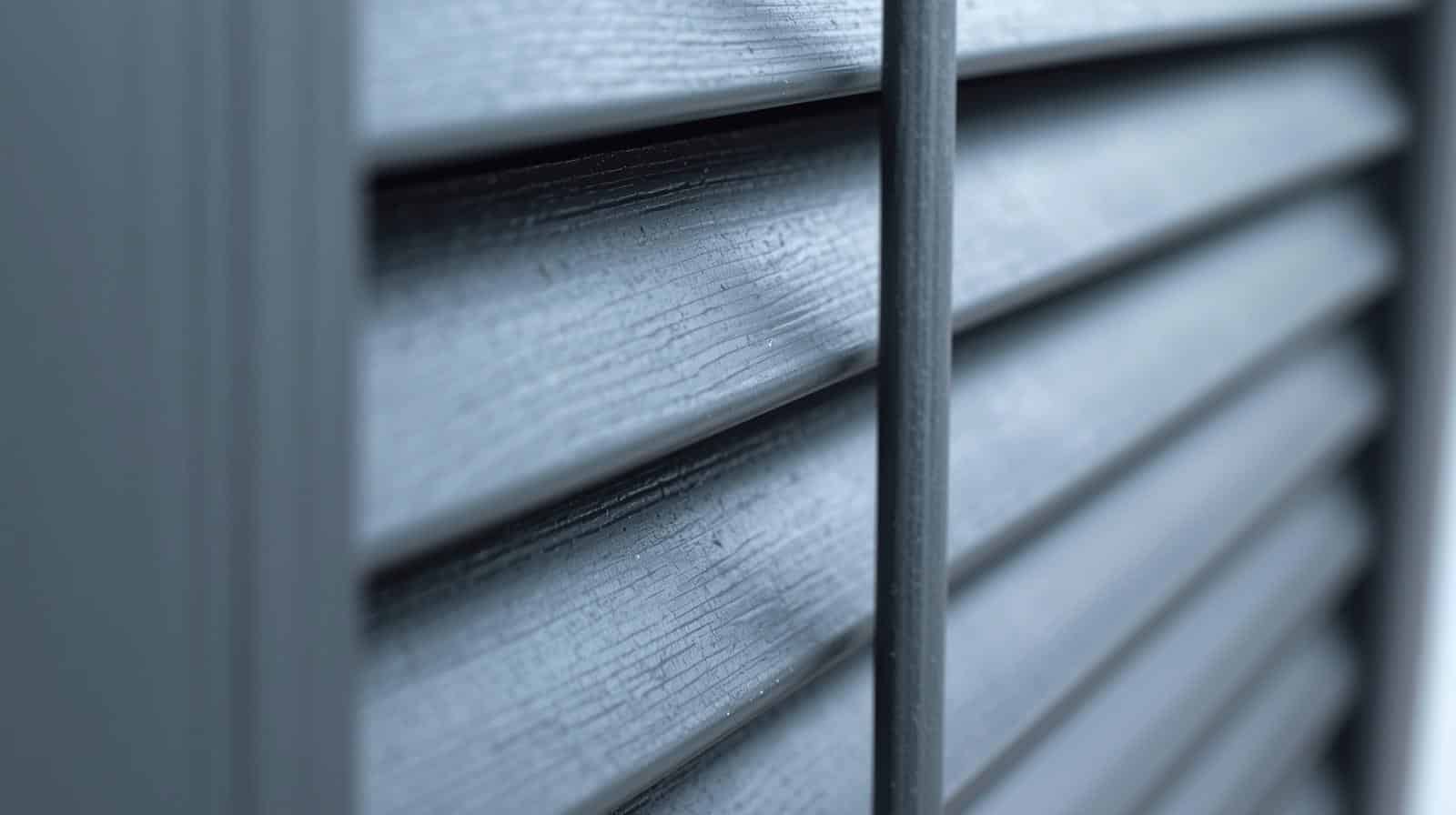 Bi-fold aluminium outdoor plantation shutters open on a Brisbane alfresco balcony