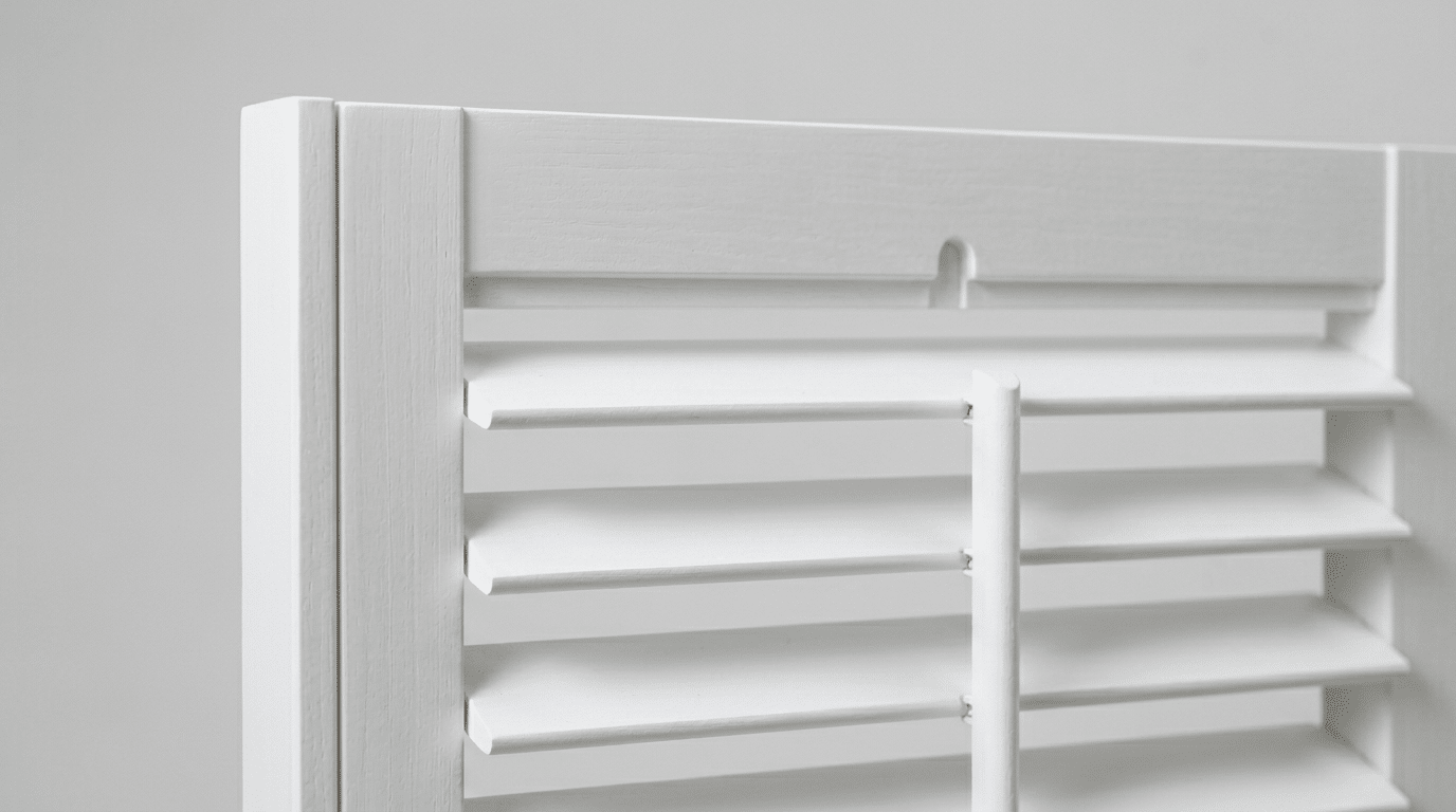 Close-up of plantation shutter panel showing solid frame construction and wide adjustable louvres