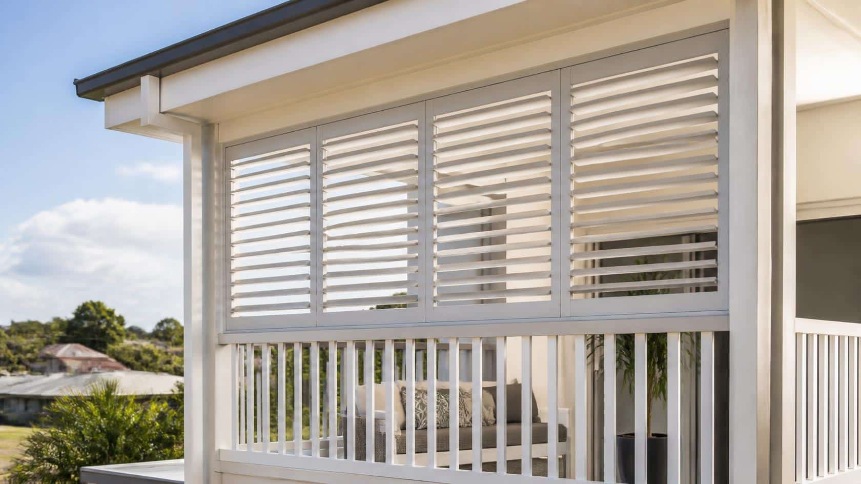 Outdoor louvre shutter panel integrated above a balcony balustrade in Brisbane